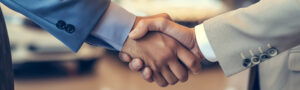 Close-up of two professionals shaking hands, symbolizing agreement, partnership, and successful dispute resolution.