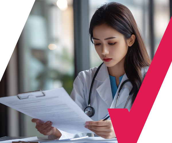 Female doctor reviewing patient documents as part of medical review process, ensuring accuracy and compliance in healthcare services.